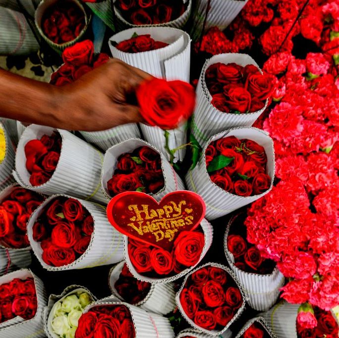 a florist arranges roses flowers at a shop ahead of valentines day in chennai on february 11, 2020 photo by arun sankar  afp photo by arun sankarafp via getty images