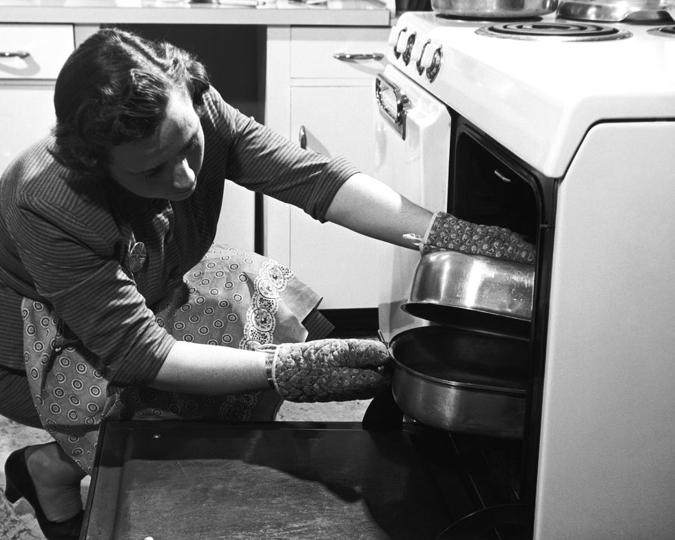 Woman Looking Inside An Oven