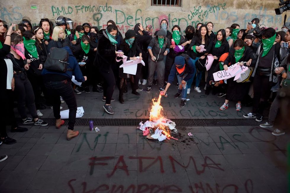 demonstrators set a fire as they gather outside the national palace, in mexico city, on february 18, 2020, to protest gender violence   dozens of women protested tuesday over the murder of a seven year old girl in the mexican capital, a case that generated anger and outrage in a country used to violence the murder of the minor shocked the country two days after hundreds of women protested in several cities in mexico over the femicide of ingrid escamilla, a 25 year old woman who was killed by her partner north of the mexican capital photo by alfredo estrella  afp photo by alfredo estrellaafp via getty images