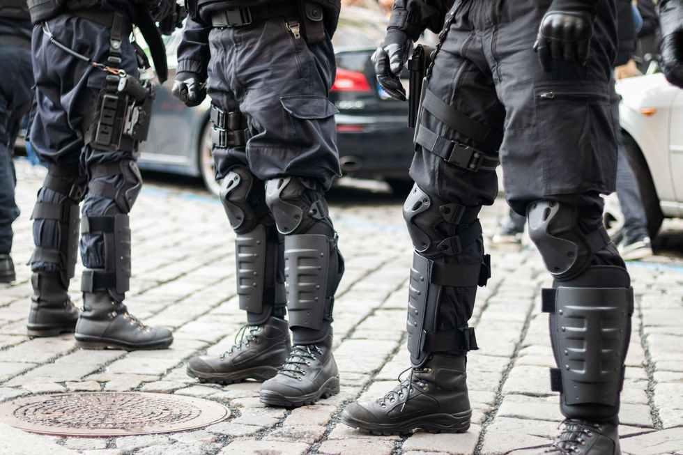 close up view to special forces wearing armored clothing and uniform security guard with weapon and guns