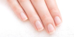 beautifully manicured fingernails of the young woman in the nail salon