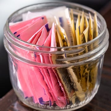 small glass bowl full of assorted artificial sweetener packets