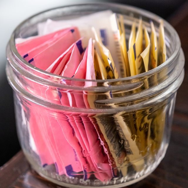 small glass bowl full of assorted artificial sweetener packets