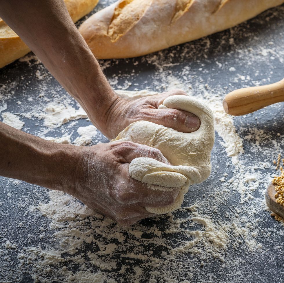 baker man hands breadmaking kneading bread dough