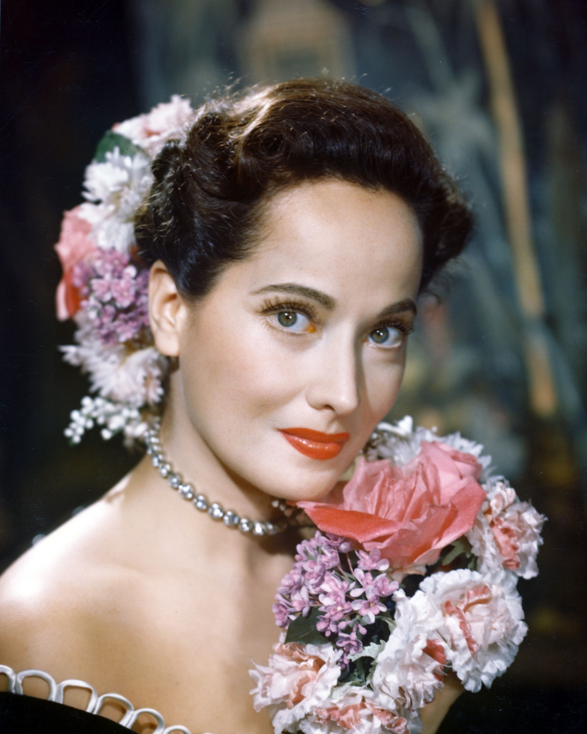 merle oberon 1911 1979, british actress, poses with a bouquet of flowers, with flowers in her hair, in a studio portrait, circa 1940 photo by silver screen collectiongetty images