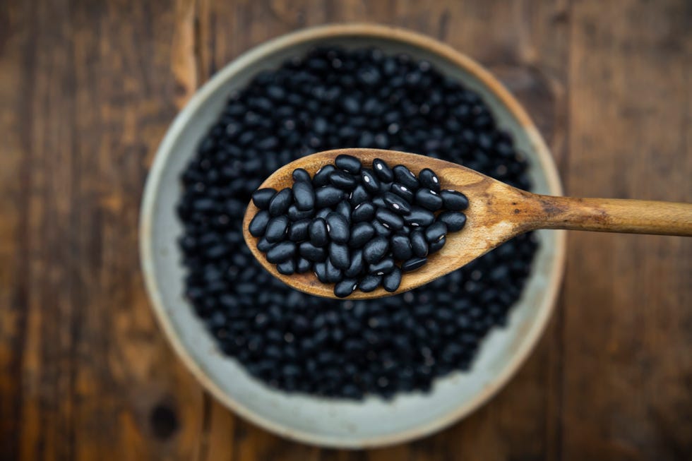 spoonful of black beans above a bowl of black beans