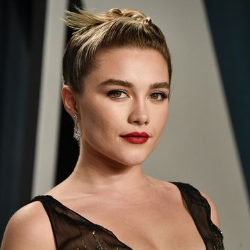 florence pugh with red lipstick and a black blouse
