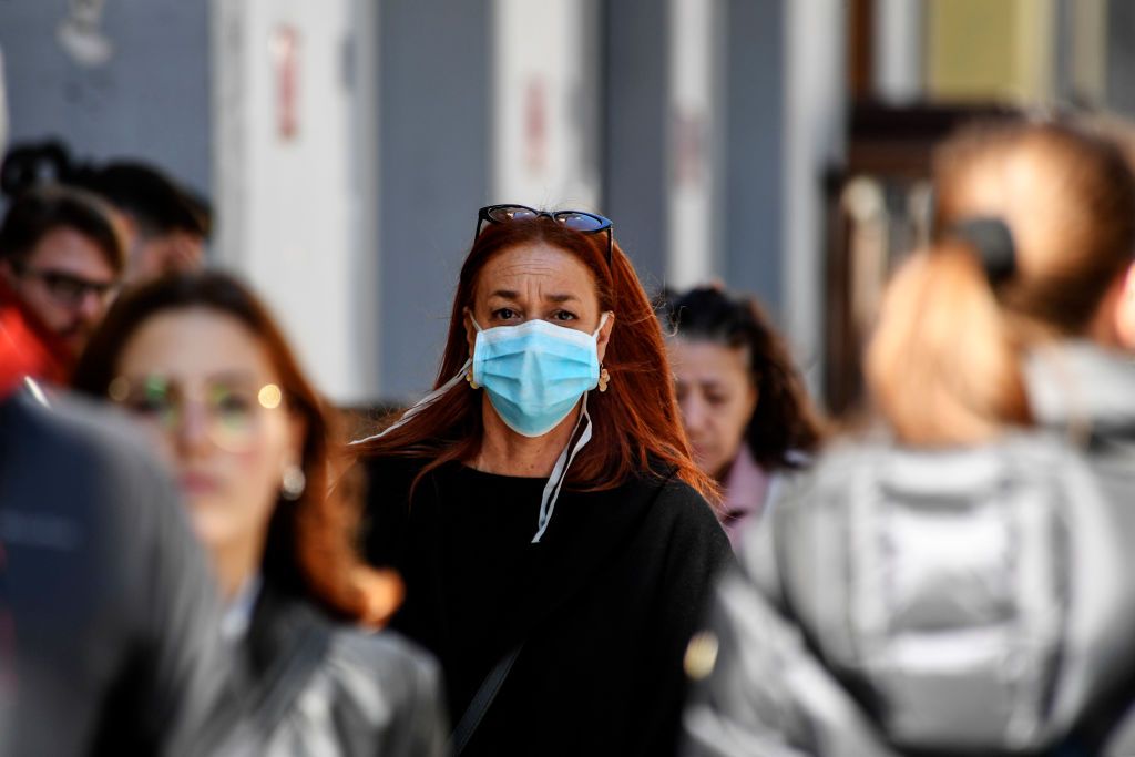 naples, campania, italy   20200305 the woman walks through the crowd of people, wearing antivirus masks to protect herself from the coronavirus covid 19 in the city of naples photo by salvatore laportakontrolablightrocket via getty images