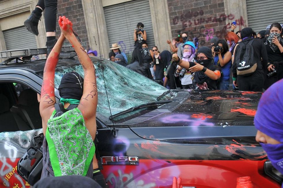 demonstrators smash a car during a march to commemorate the international womens day, in mexico city on march 8, 2020   people around the globe are taking action to mark international womens day and to push for action to to obtain equality photo by rocio vazquez  afp photo by rocio vazquezafp via getty images