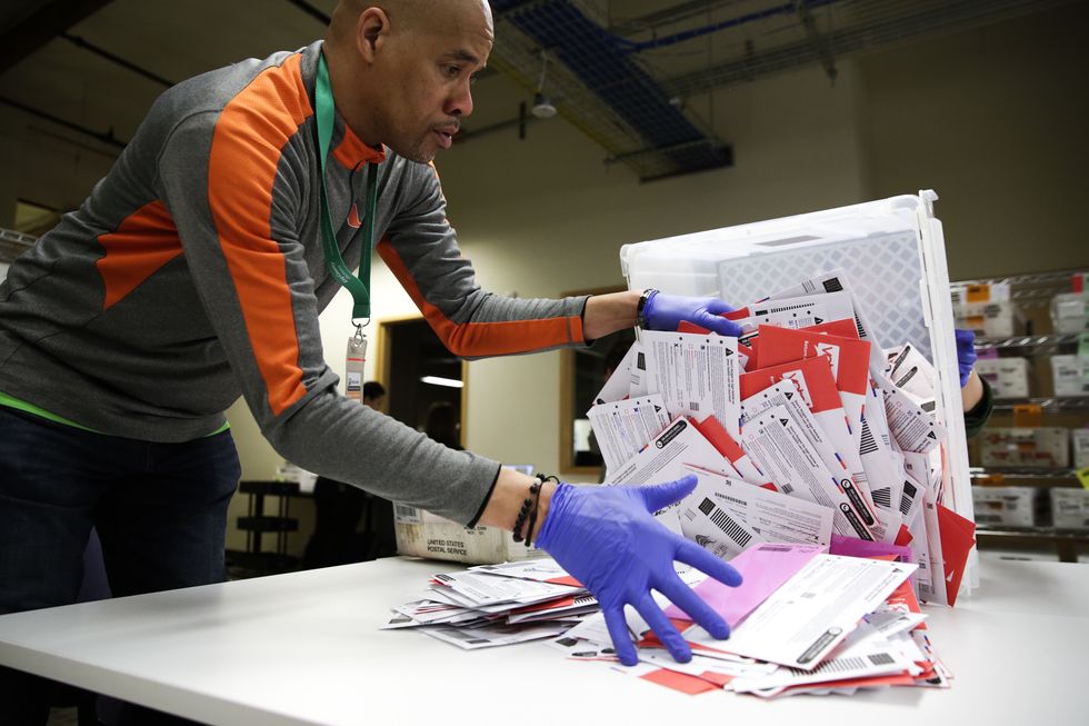 election worker erick moss sorts vote by mail ballots for the presidential primary at king county elections in renton, washington on march 10, 2020 photo by jason redmond  afp photo by jason redmondafp via getty images