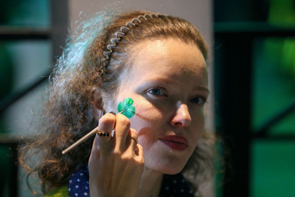 moscow, russia   march 14, 2020 a girl painting a shamrock leaf on her cheek during the folk festival st patricks day and night at moscows izvestia hall gavriil grigorovtass photo by gavriil grigorov\tass via getty images