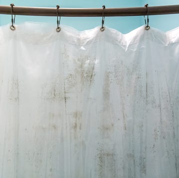 How to clean your shower curtain dark brown mildew mold on plastic interior shower curtain in a light aqua bathroom inside the bathtub and shower area