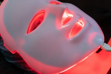 red glowing cosmetology mask for phototherapy at the spa