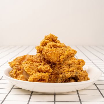 close up fried chickens on white plate isolated on table look yummy and yellow gold color