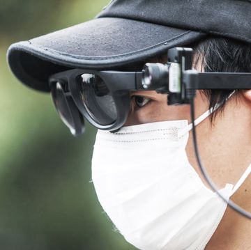 hangzhou, china   march 24 2020 a security guard looks at the tourists through his augmented reality ar eyewear equipped with an infrared temperature detector in xixi wetland park in hangzhou in east china's zhejiang province tuesday, march 24, 2020 the eyewear will alert the guard when it detects someone with fever signs, the latest weapon in the fight against the covid 19  photograph by feature china  barcroft studios  future publishing photo credit should read feature chinabarcroft media via getty images