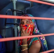 INDIA-HEALTH-VIRUS-MIGRANT a migrant worker looks out of a compartments window as she sits inside a special train going to agra in uttar pradesh state during a government imposed nationwide lockdown as a preventive measure against the covid 19 coronavirus, at sabarmati railway station on the outskirts of ahmedabad on may 2, 2020 photo by sam panthaky afp photo by sam panthakyafp via getty images