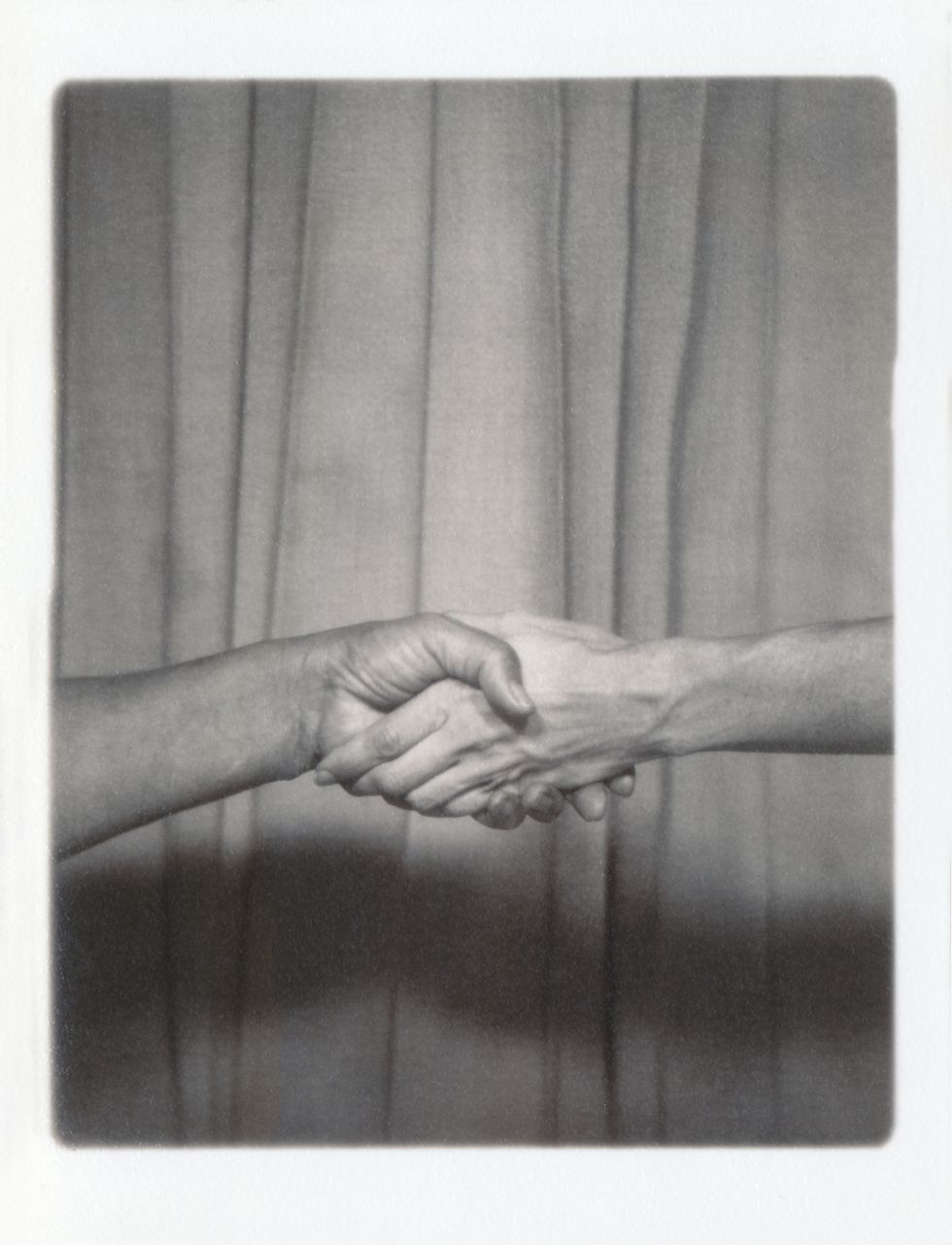 two people shaking hands conceptual image for partnership, networking and friendship vintage style photograph in black and white