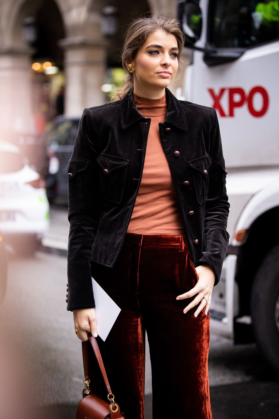 paris, france   march 02  a guest, wearing a brown turtleneck top, orange velvet pants and black jacket, is seen outside giambattista valli, during paris fashion week   womenswear fallwinter 20202021  day eight on march 02, 2020 in paris, france photo by claudio laveniagetty images