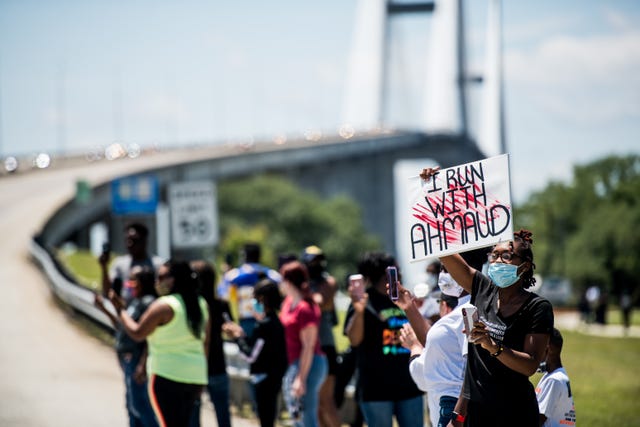 brunswick, ga   may 09 demonstrators watch a parade of passing motorcyclists riding in honor of ahmaud arbery at sidney lanier park on may 9, 2020 in brunswick, georgia arbery was shot and killed while jogging in the nearby satilla shores neighborhood on february 23 photo by sean rayfordgetty images