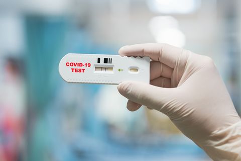 doctor hand holding positive coronavirus or covid 19 rapid test