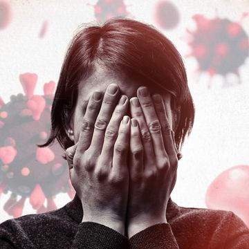 concept of fear of coronavirus woman covers her face her hands on background with coronavirus