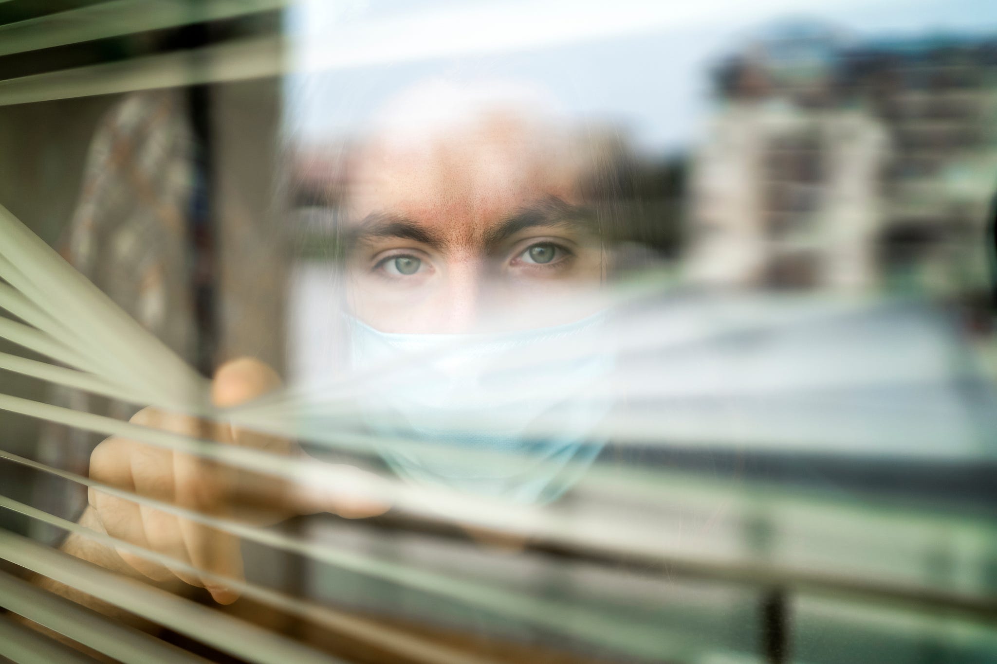 concerned healthcare worker looking through a window