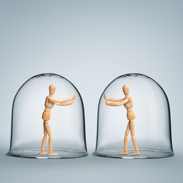 human puppets each in it's own glass bubble expressing love while being apart from each other