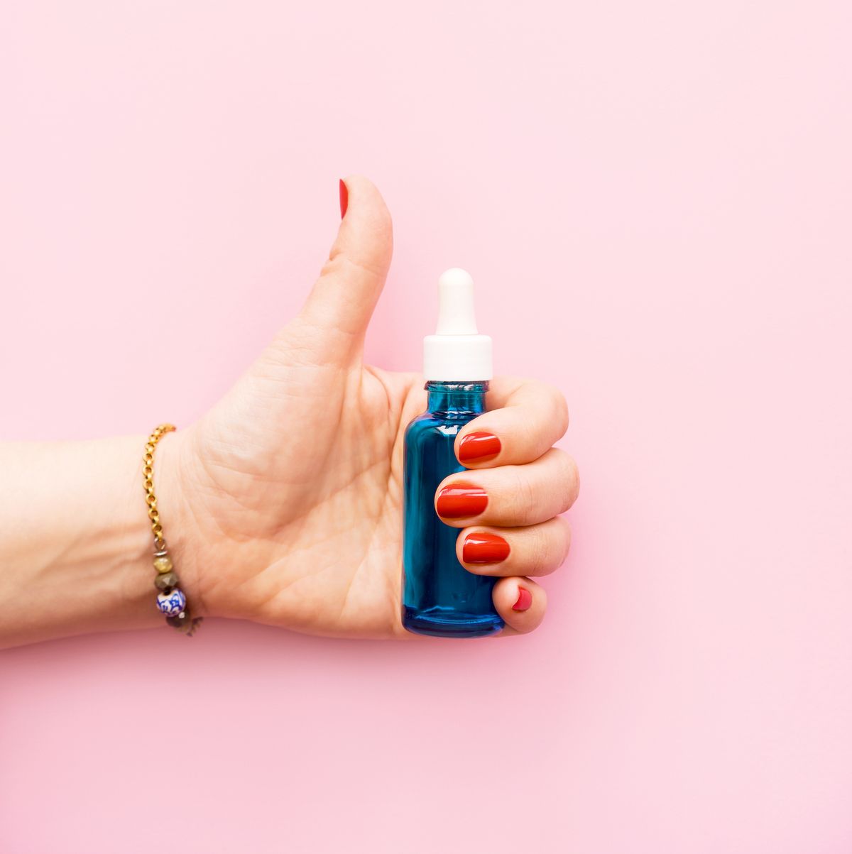 Hyaluronic acid and collagen bottle  in female hand