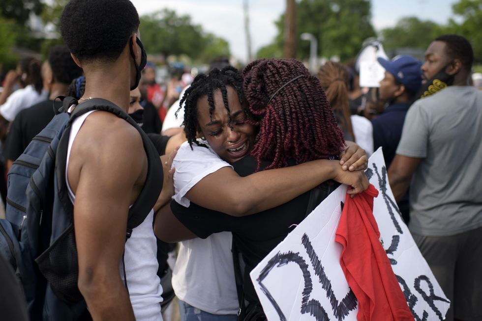 topshot   george floyds niece gabrielle thompson c cries as she hugs another woman during a justice for george floyd event in houston, texas on may 30, 2020, after george floyd, an unarmed black, died while being arrested and pinned to the ground by a minneapolis police officer   clashes broke out and major cities imposed curfews as america began another night of unrest saturday with angry demonstrators ignoring warnings from president donald trump that his government would stop violent protests over police brutality cold photo by mark felix  afp photo by mark felixafp via getty images