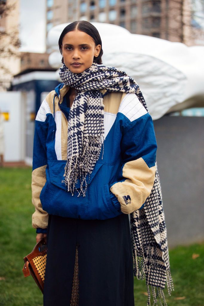 london, england   february 17 model malaika holmen wears a blue and white knit scarf, blue and gold sports starter windbreaker jacket after the christopher kane show during london fashion week february 2020 on february 17, 2020 in london, england photo by melodie jenggetty images