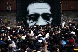 minneapolis, mn   june 2 a painting of george floyd stands behind a group of people gathered at a memorial on the block where he was killed by police on june 2, 2020 in minneapolis, minnesota a group of clergy marched to the site to give prayers and call for justice photo by stephen maturengetty images