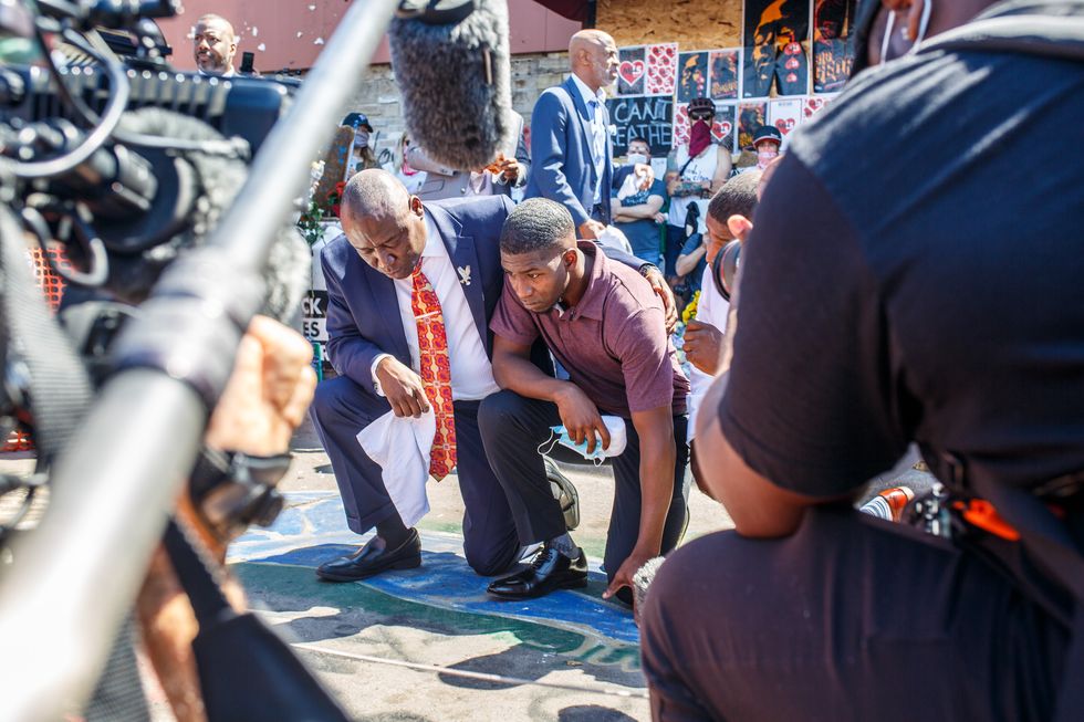 topshot   george floyds son, quincy mason floyd c r and family attorney ben crump c l pray on june 3, 2020, at the site where george floyd died in minneapolis, minnesota photo by kerem yucel  afp photo by kerem yucelafp via getty images