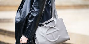 paris, france   february 27 a guest wears a black leather jacket and a gray bag with a t logo, outside ann demeulemeester, during paris fashion week   womenswear fallwinter 20202021, on february 27, 2020 in paris, france photo by edward berthelotgetty images