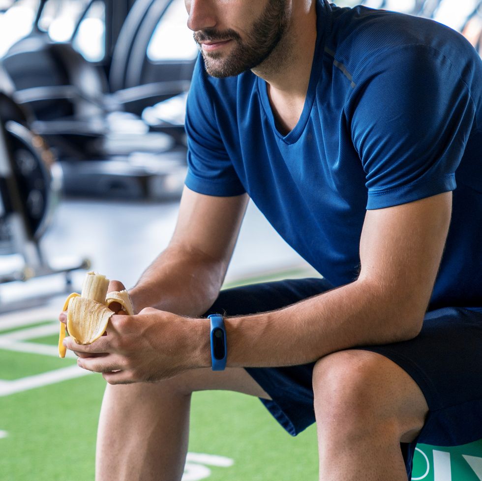 athletes in blue clothes eat bananas after exercise