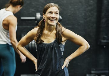 a person smiling with the arms crossed