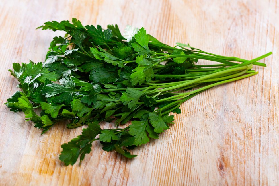 green parsley on wooden table closeup