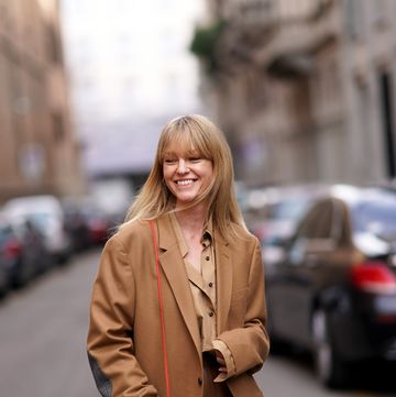 milan, italy february 21 jeanette madsen wears a brown oversized blazer jacket, a red bag, brown leather pants, a brown shirt, outside sportmax, during milan fashion week fallwinter 2020 2021 on february 21, 2020 in milan, italy photo by edward berthelotgetty images