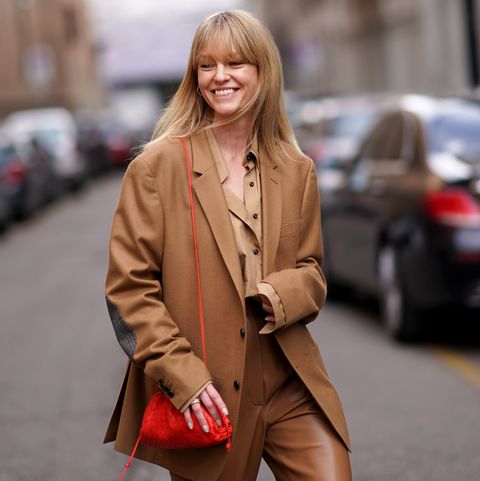 milan, italy february 21 jeanette madsen wears a brown oversized blazer jacket, a red bag, brown leather pants, a brown shirt, outside sportmax, during milan fashion week fallwinter 2020 2021 on february 21, 2020 in milan, italy photo by edward berthelotgetty images