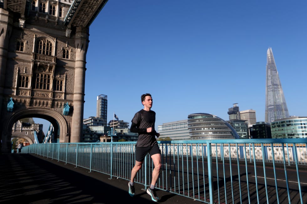 a lonely jogger on tower ﻿bridge, jogging﻿