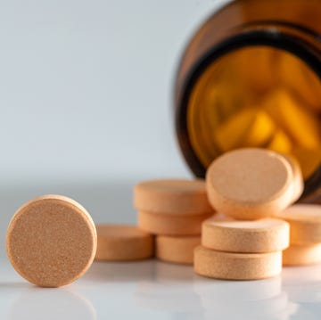 yellow vitamin pills isolated on a white background