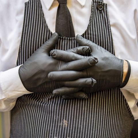 a waiter wears black protective gloves in italy photographer francesca volpibloomberg