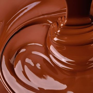 splash of melted chocolate sweet cocoa dessert, dark chocolate background