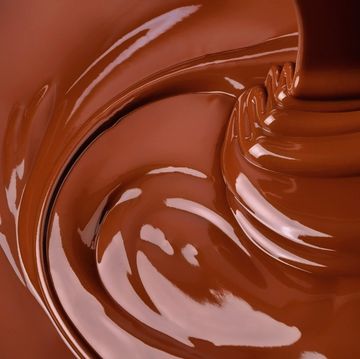 splash of melted chocolate sweet cocoa dessert, dark chocolate background