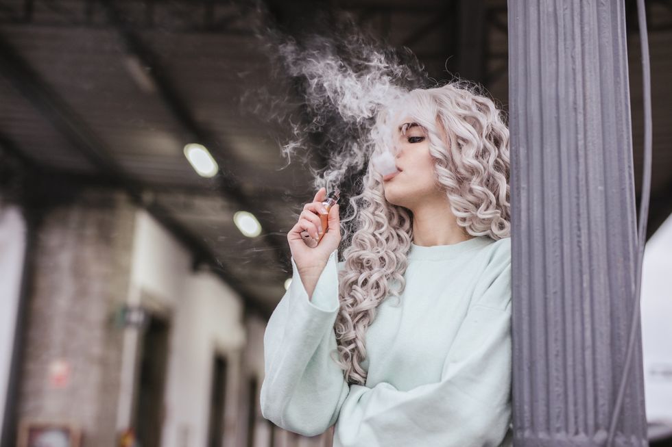 young blonde woman vaping
