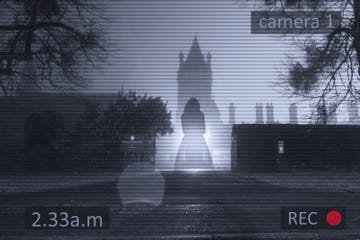 a floating transparent ghostly woman standing in front of a gothic old tower with a cctv surveillance edit