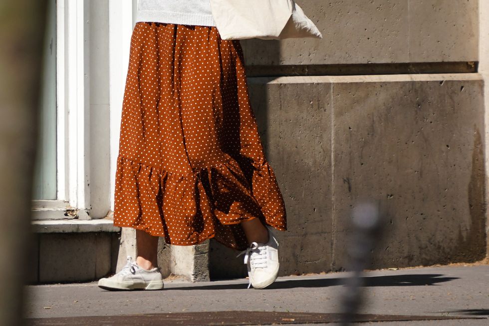 paris, france   may 14 a passerby wears a ruffled brown skirt with polka dots, white sneakers, in the streets of paris, on may 14, 2020 in paris, france photo by edward berthelotgetty images