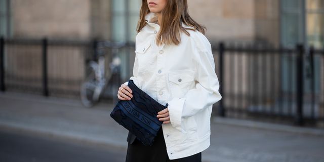 berlin, germany   may 21 swantje soemmer is seen wearing white denim jacket calvin klein, black asymmetric skirt aeron, dior clutch in navy, prada sunglasses on may 21, 2020 in berlin, germany photo by christian vieriggetty images