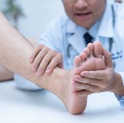 the doctor is examining the patients feet doctor dermatologist examines the foot on the presence of athletes foot