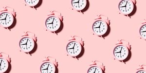 pink alarm clock on a pastel gentle dusty background flat lay seamless pattern