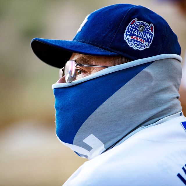 man with baseball cap and neck gaiter